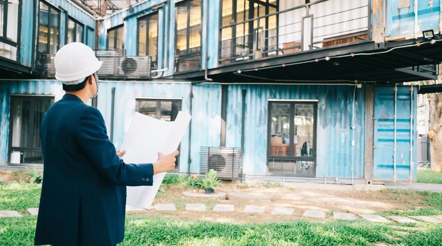 Architect examining blueprint of building site