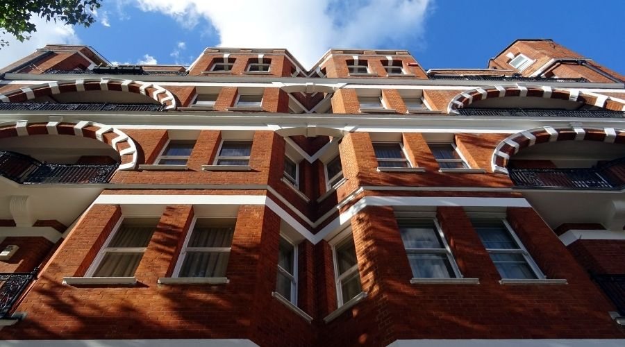 Red brick building with ornate arches and balconies.