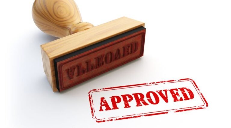 Wooden stamp with red 'Approved' text