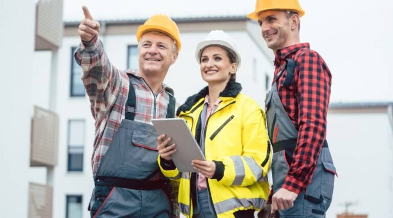 Construction workers discussing project on site.