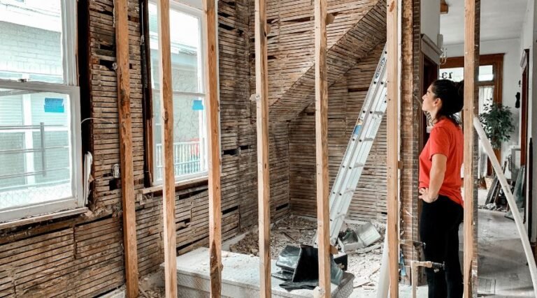 Woman inspecting home renovation construction site.