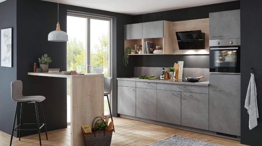 Modern kitchen with gray cabinets and breakfast bar.