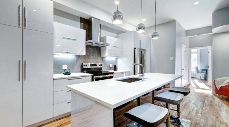 Modern kitchen with island and pendant lighting.