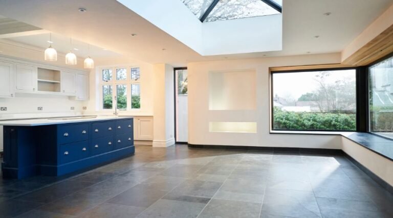 Modern kitchen with skylight and blue island.