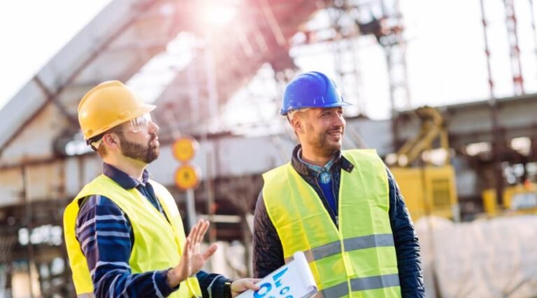 Construction workers discussing project on site.