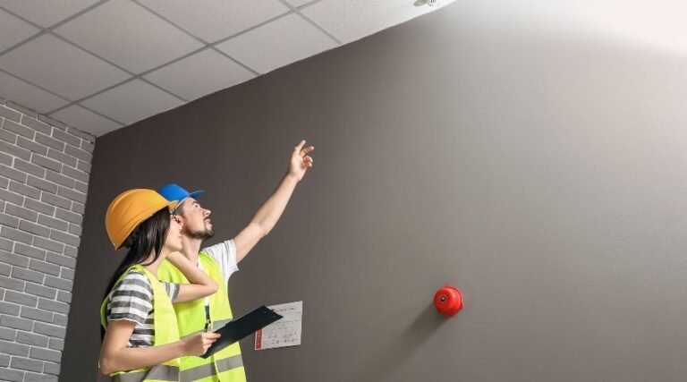 Inspectors reviewing ceiling for maintenance issues